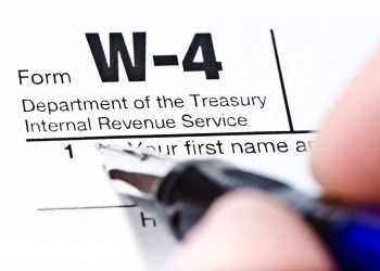 The process of filling out the W-4 form, shallow depth of field